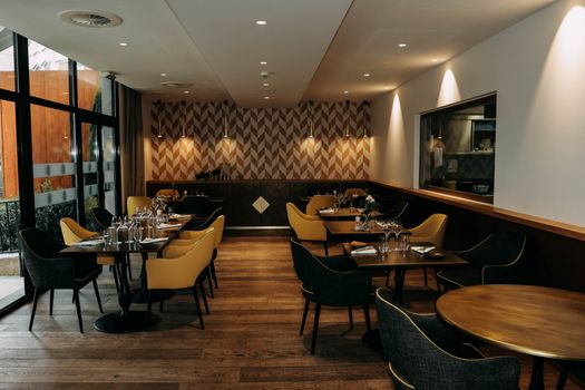 Stylish restaurant interior featuring modern decor, elegant furniture, and well-set dining tables.