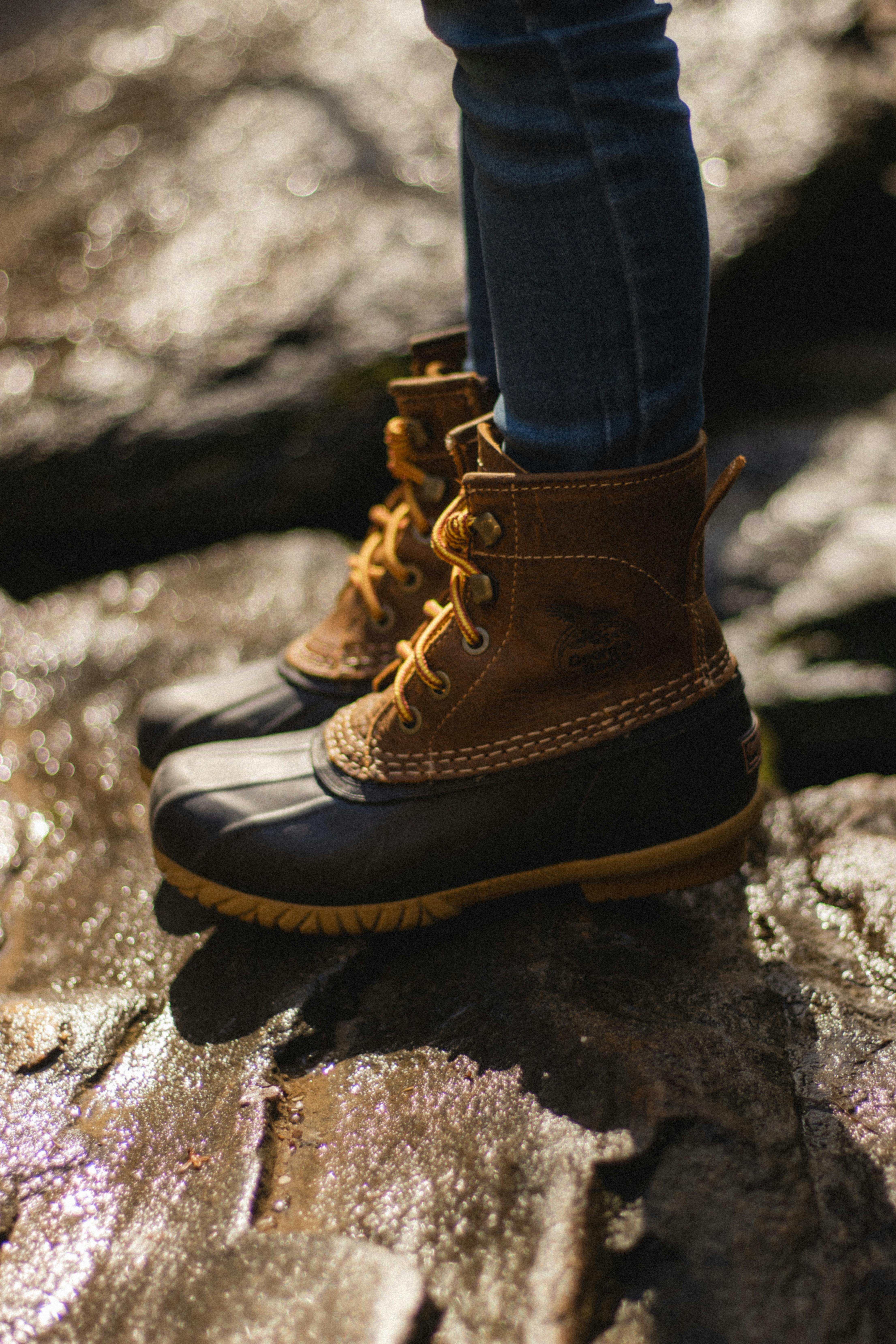 Close-up of durable boots on rocky terrain, perfect for outdoor adventures.