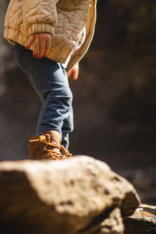 Kids Rugged Child Exploring Outdoors in Rugged Boots · Free Stock Photo