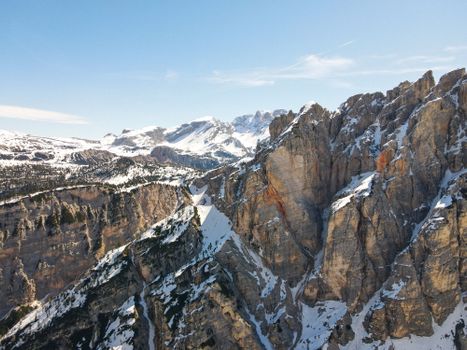 A breathtaking aerial view of snow-capped mountain peaks under a clear blue sky.