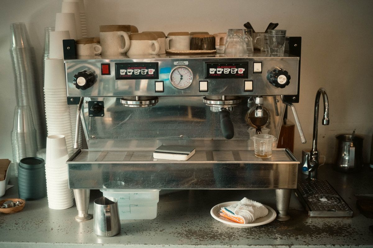 Espresso machine in a warm cafe setting, for illustration