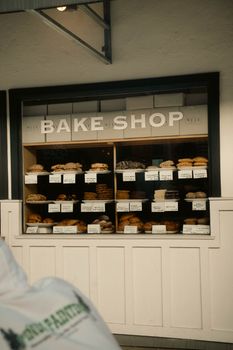 A cozy bakery shop window showcasing a variety of fresh bread and pastries.