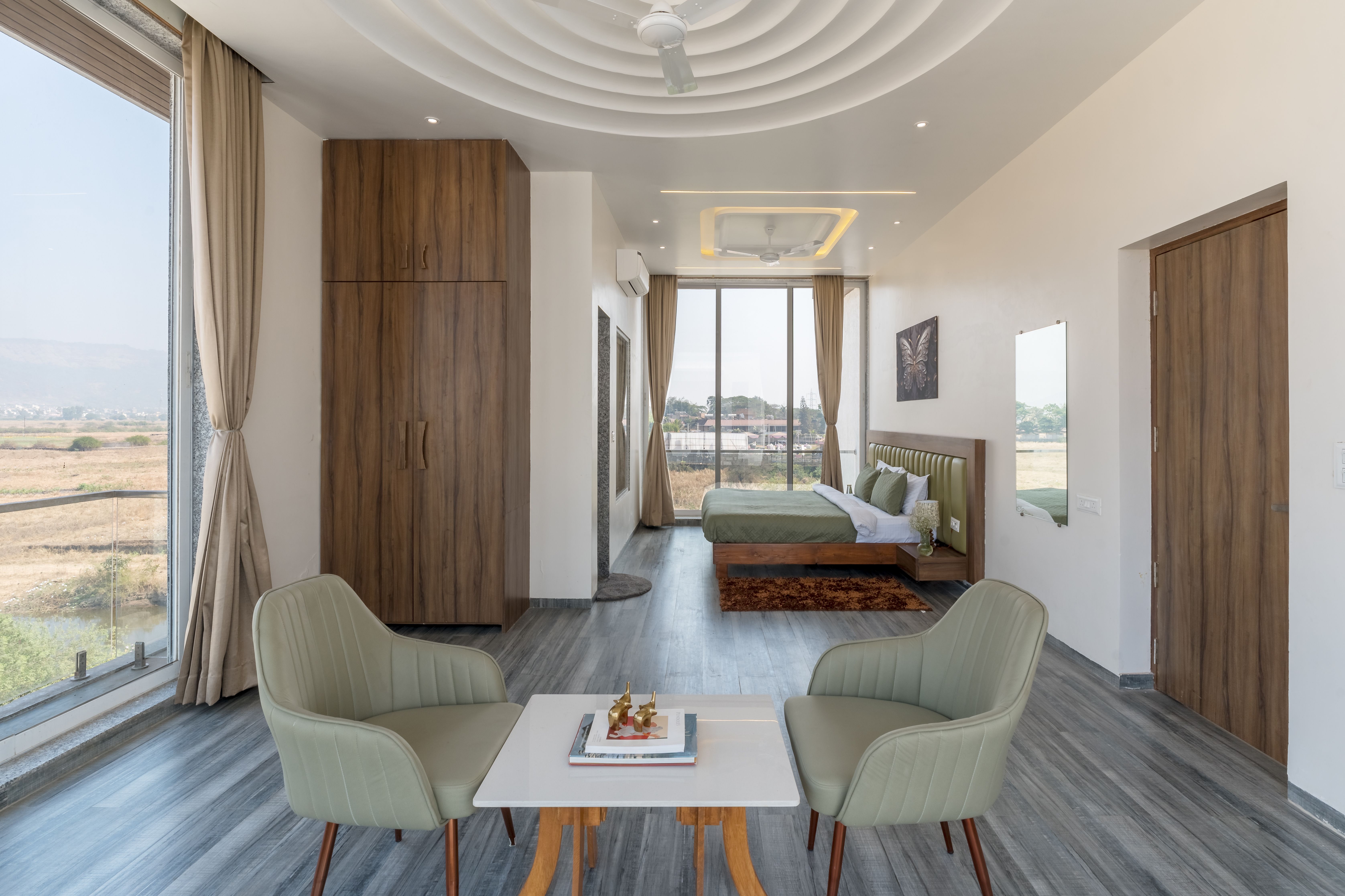 A minimalist ultra-luxury hotel suite featuring clean lines, neutral tones, and a panoramic view of the ocean.