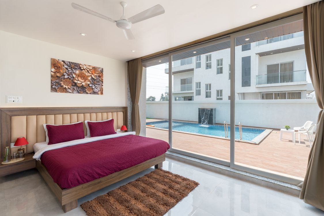 Luxury Bedroom Overlooking Pool with Modern Decor · Free Stock Photo