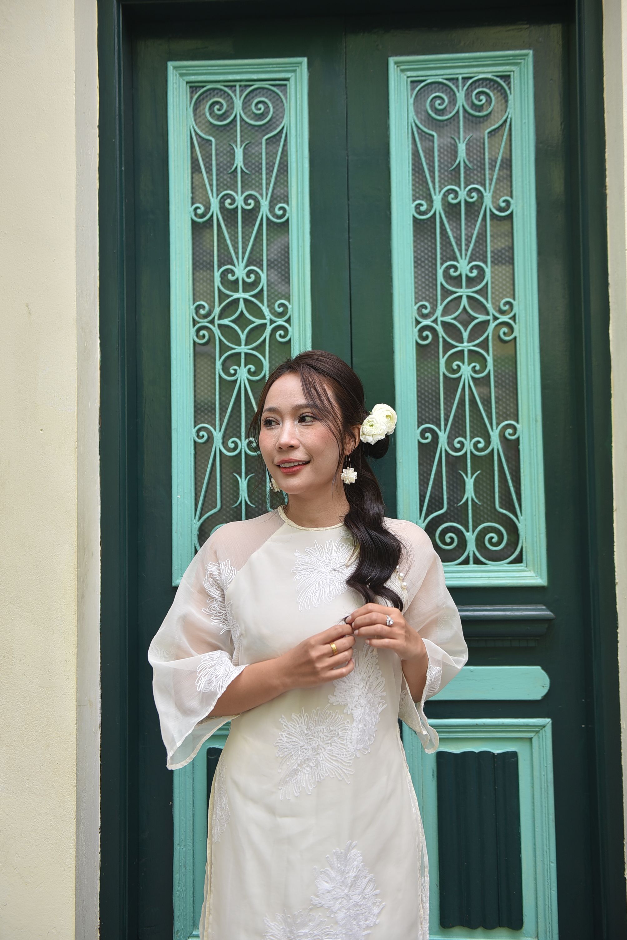 Elegant Woman in Traditional Dress by Ornate Door · Free Stock Photo