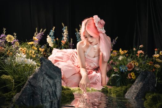 A fantasy-inspired portrait of a woman with pink hair dressed as a fairy surrounded by vibrant flowers.