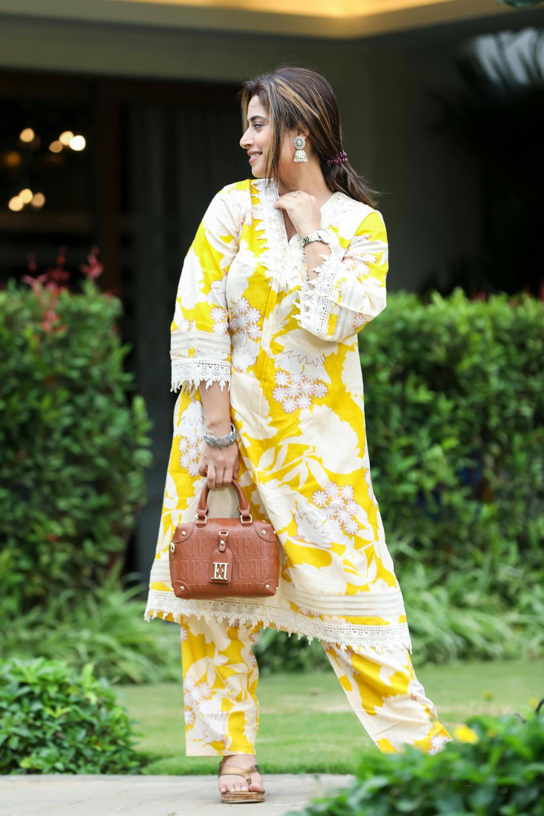 Vibrant yellow floral kurti with high-low hemline and contrast piping