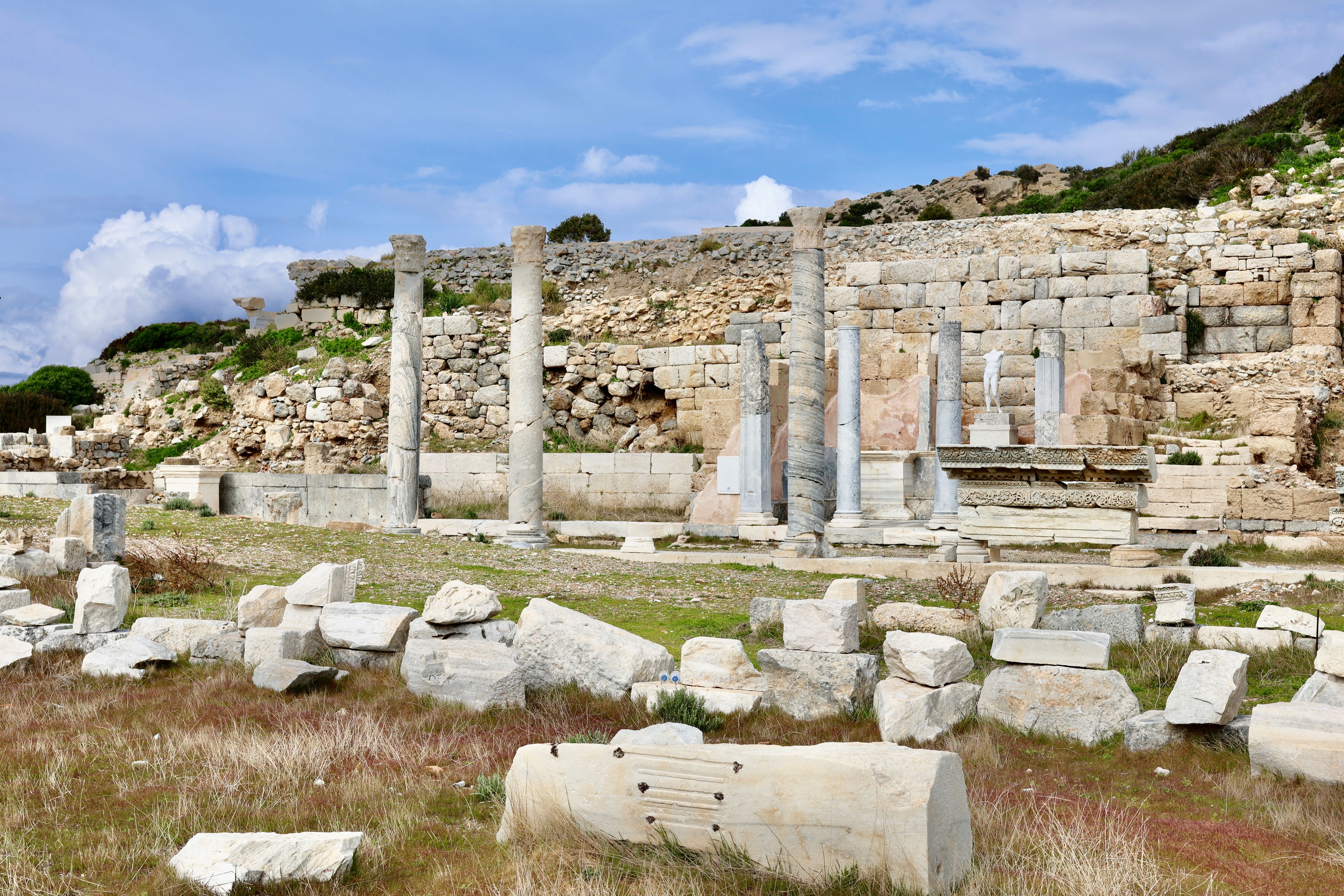 Explore the ancient ruins of Knidos, showcasing historical stone structures under a bright sky.
