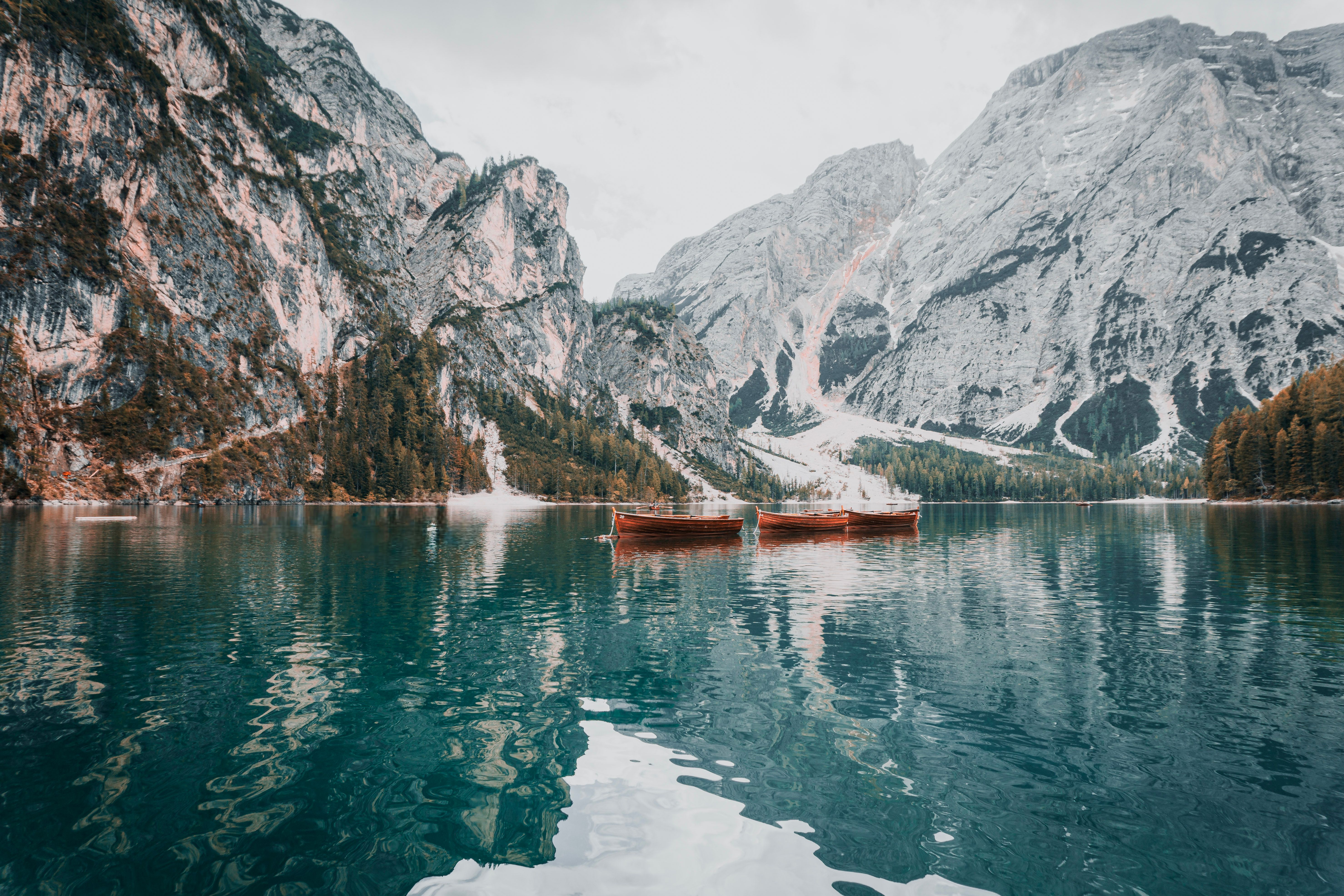 Rowboats on Lago di Braies below pale limestone peaks, an easy lake stop for the Dolomites without hiking