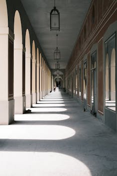 Beautiful corridor with columns and archways in Munich showcasing elegant European architecture.