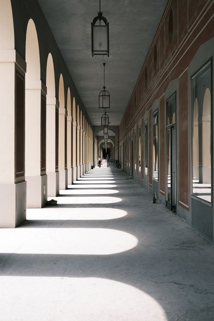 Beautiful corridor with columns and archways in Munich showcasing elegant European architecture.