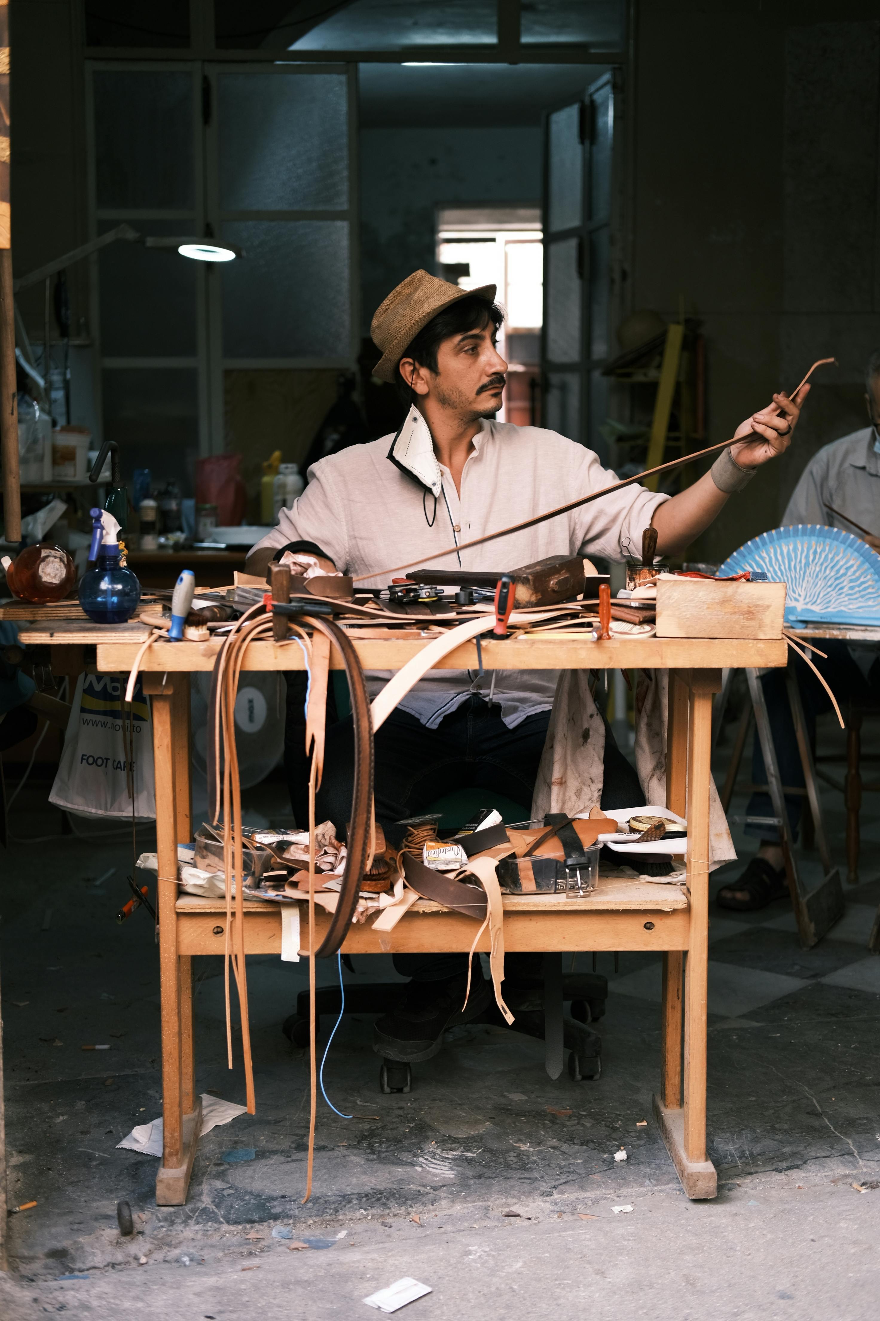 Skilled artisan shaping leather in a traditional Sicilian workshop.