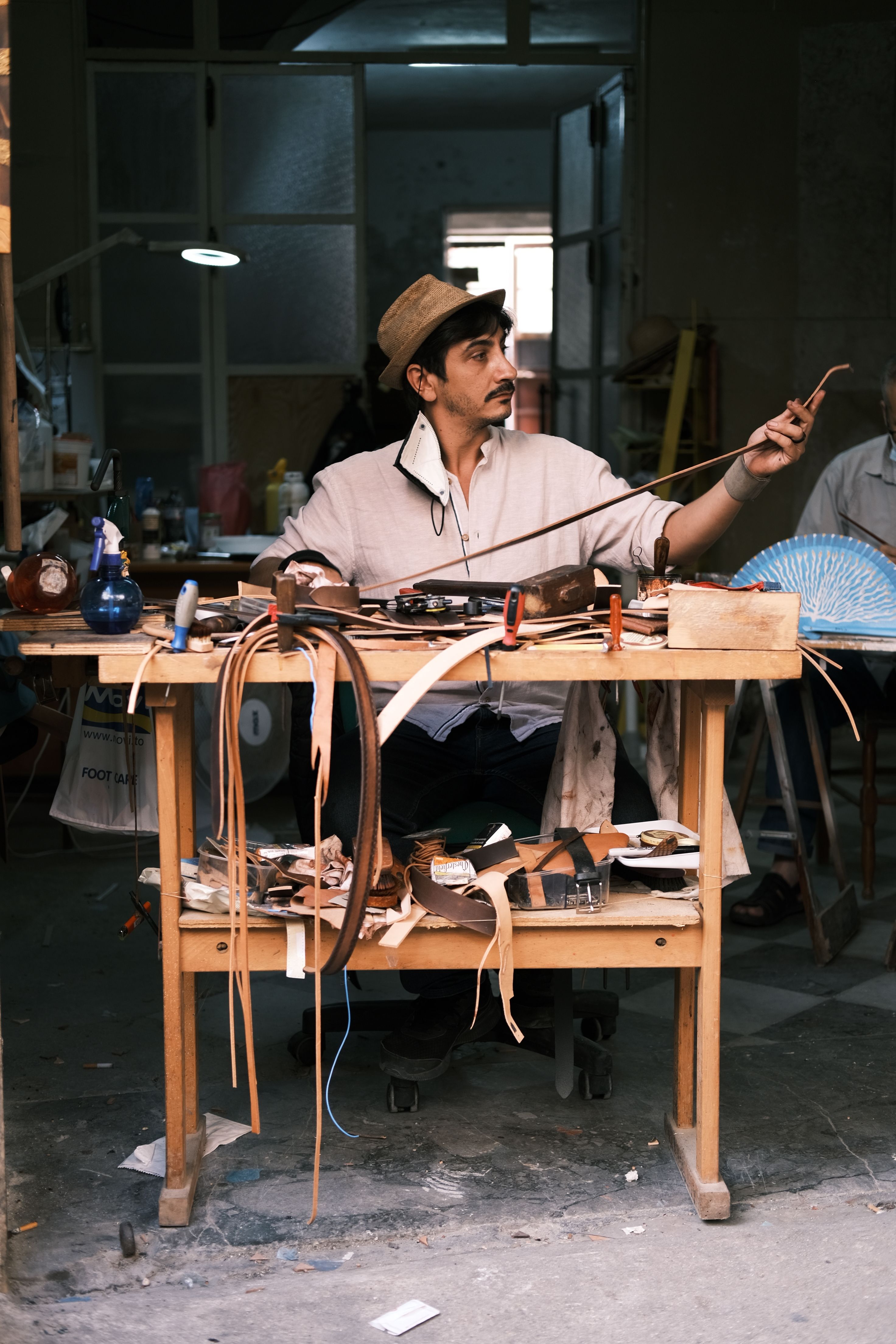 Craftsman shaping a bow riser by hand in the workshop