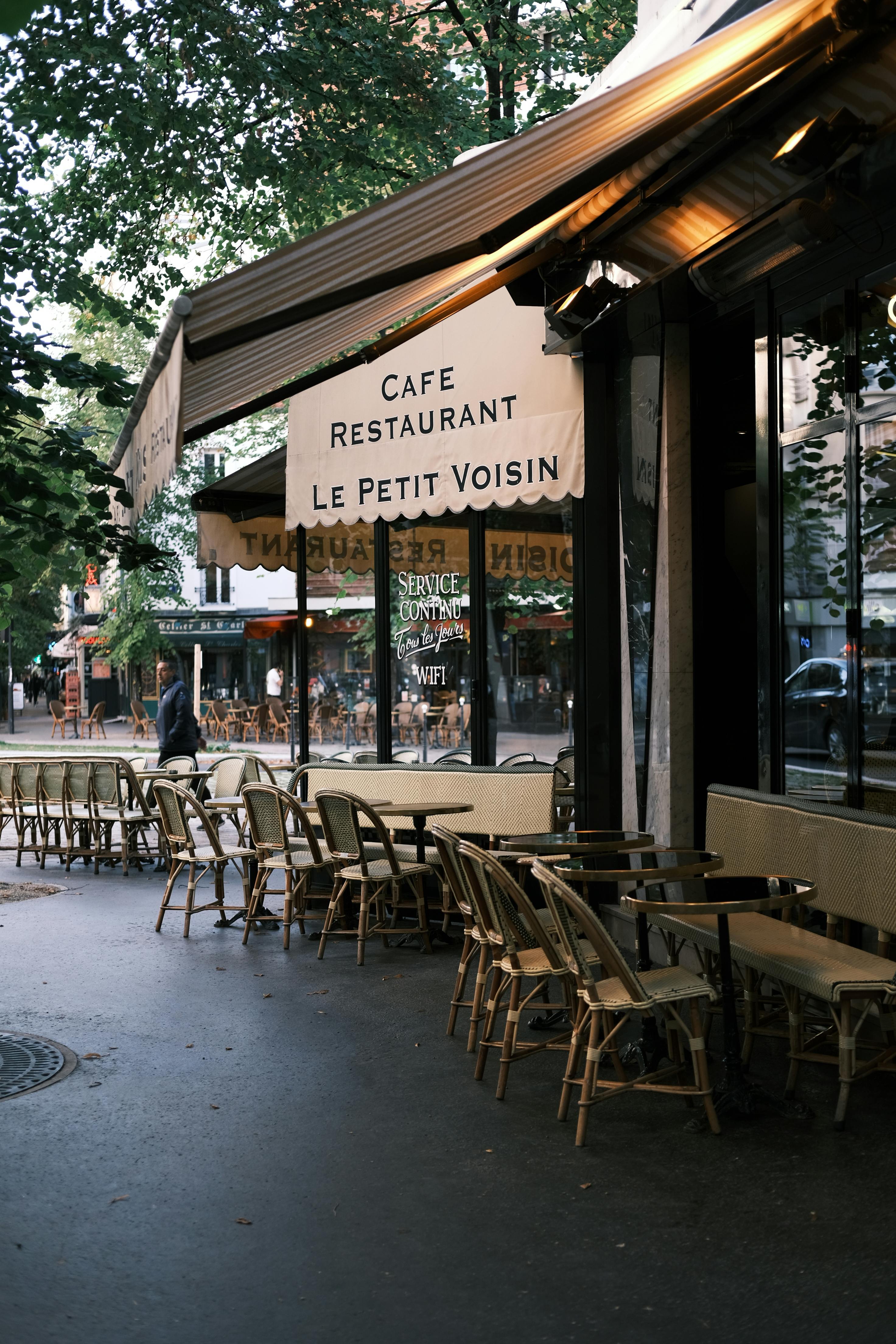 Discover the quaint charm of a Parisian street cafe with outdoor seating. Perfect for morning coffee in a cozy atmosphere.