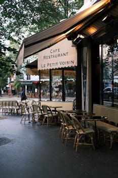 Discover the quaint charm of a Parisian street cafe with outdoor seating. Perfect for morning coffee in a cozy atmosphere.