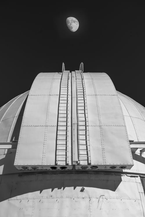 Free A striking black and white image of an observatory dome with the moon above in Canberra, Australia. Stock Photo