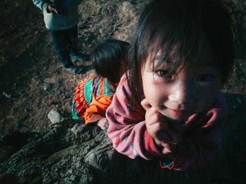 Free Smiling child in traditional clothing outdoors in Hà Giang, Vietnam. Stock Photo