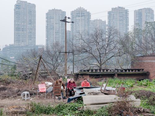 Free A rural scene with people against a backdrop of modern apartments. Stock Photo