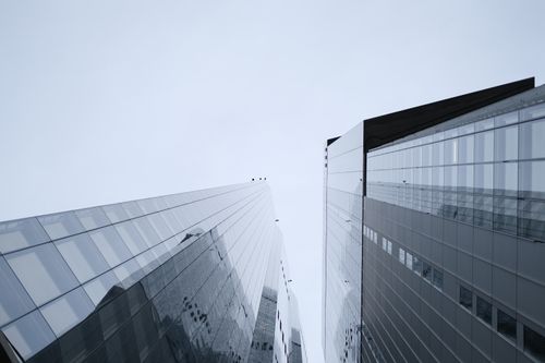 Free Glass skyscrapers reflecting the cityscape in London's financial center. Stock Photo