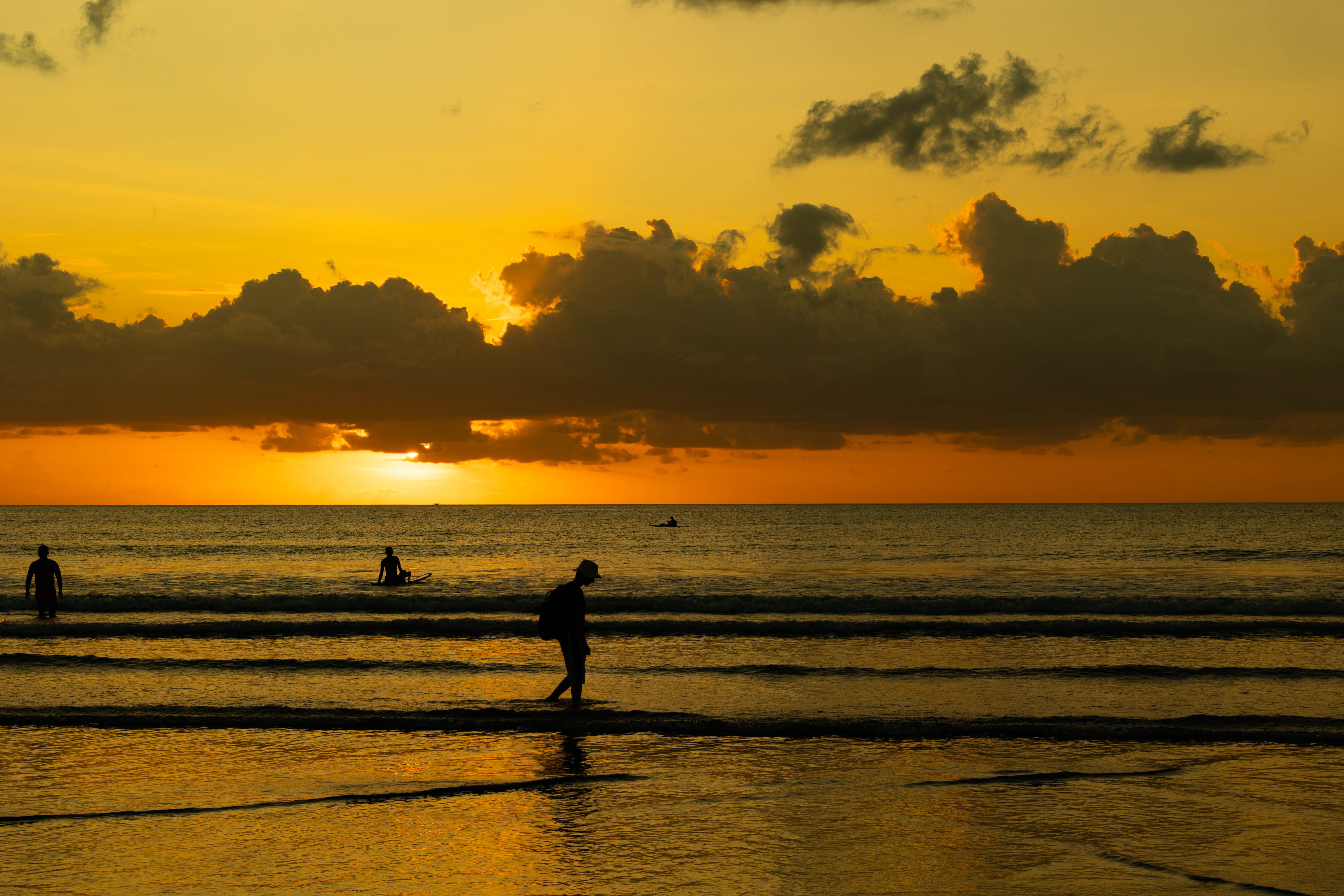 Silhouettes on Beach During Stunning Sunset · Free Stock Photo