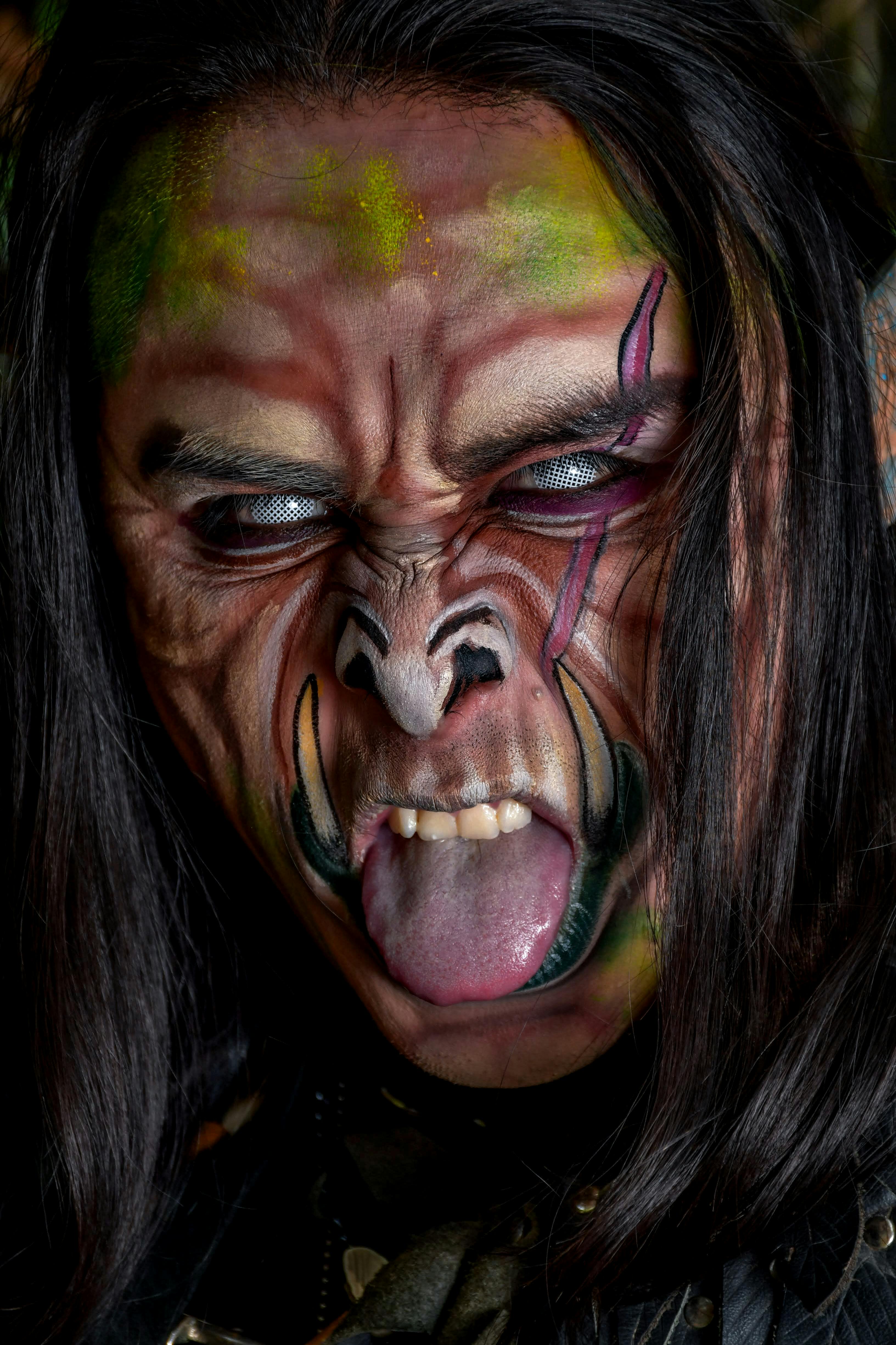 Close-up of a person with elaborate fantasy makeup resembling a fictional creature.