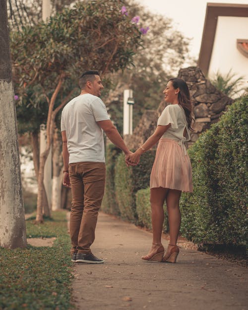 Free Photo of Smiling Couple Standing on Side Walk While Holding Hands Stock Photo