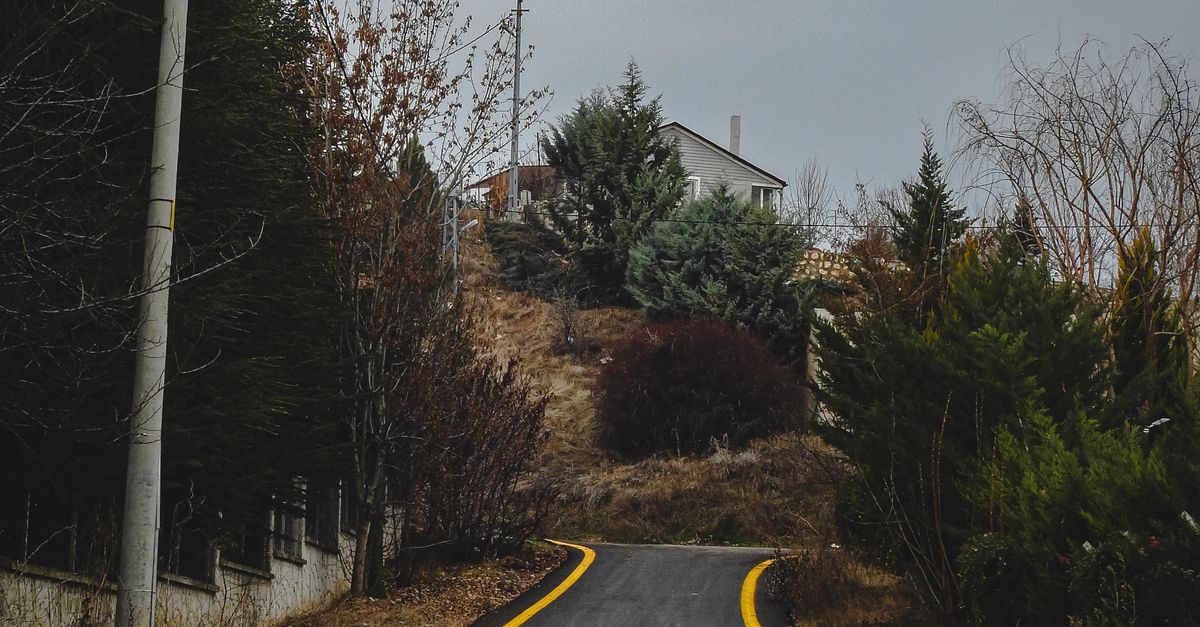 Rural Rode No Filter Scenic Rural Road Leading to Hilltop House · Free Stock Photo