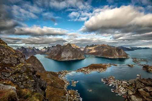 Landscape Photography of Mountains Surrounded by Water