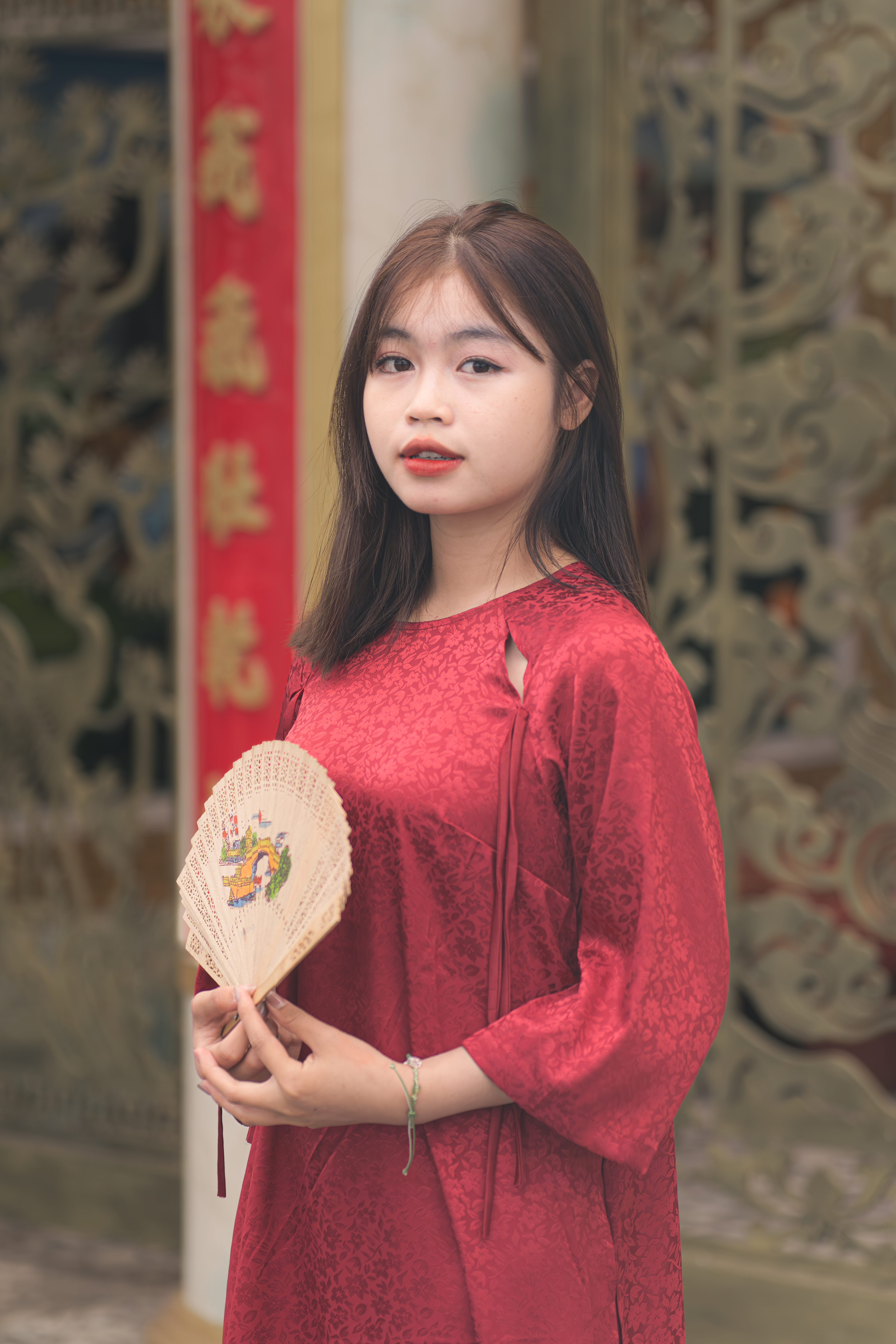 Young Woman in Traditional Red Attire with Fan · Free Stock Photo