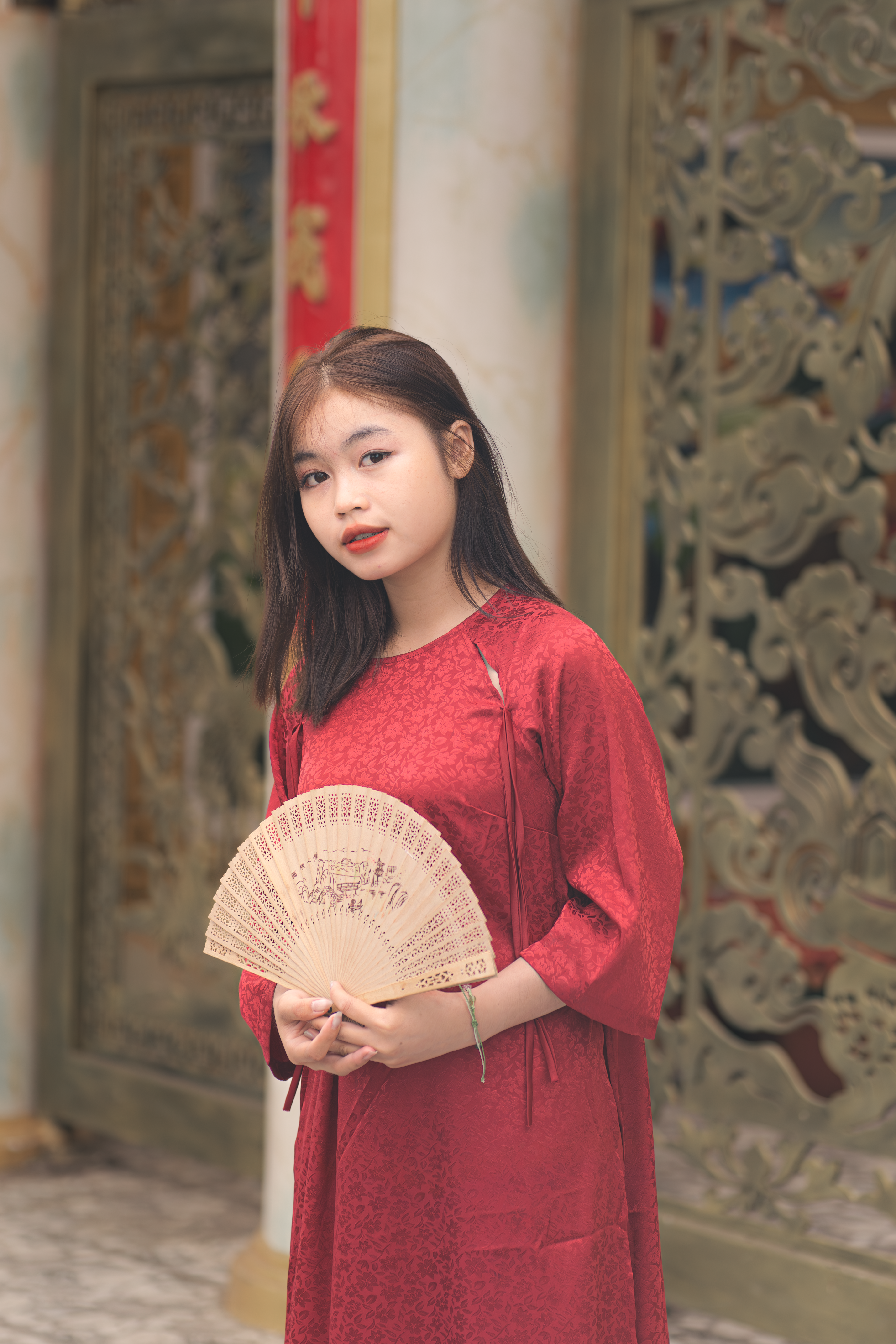 Young Woman in Red Traditional Dress Holding a Fan · Free Stock Photo