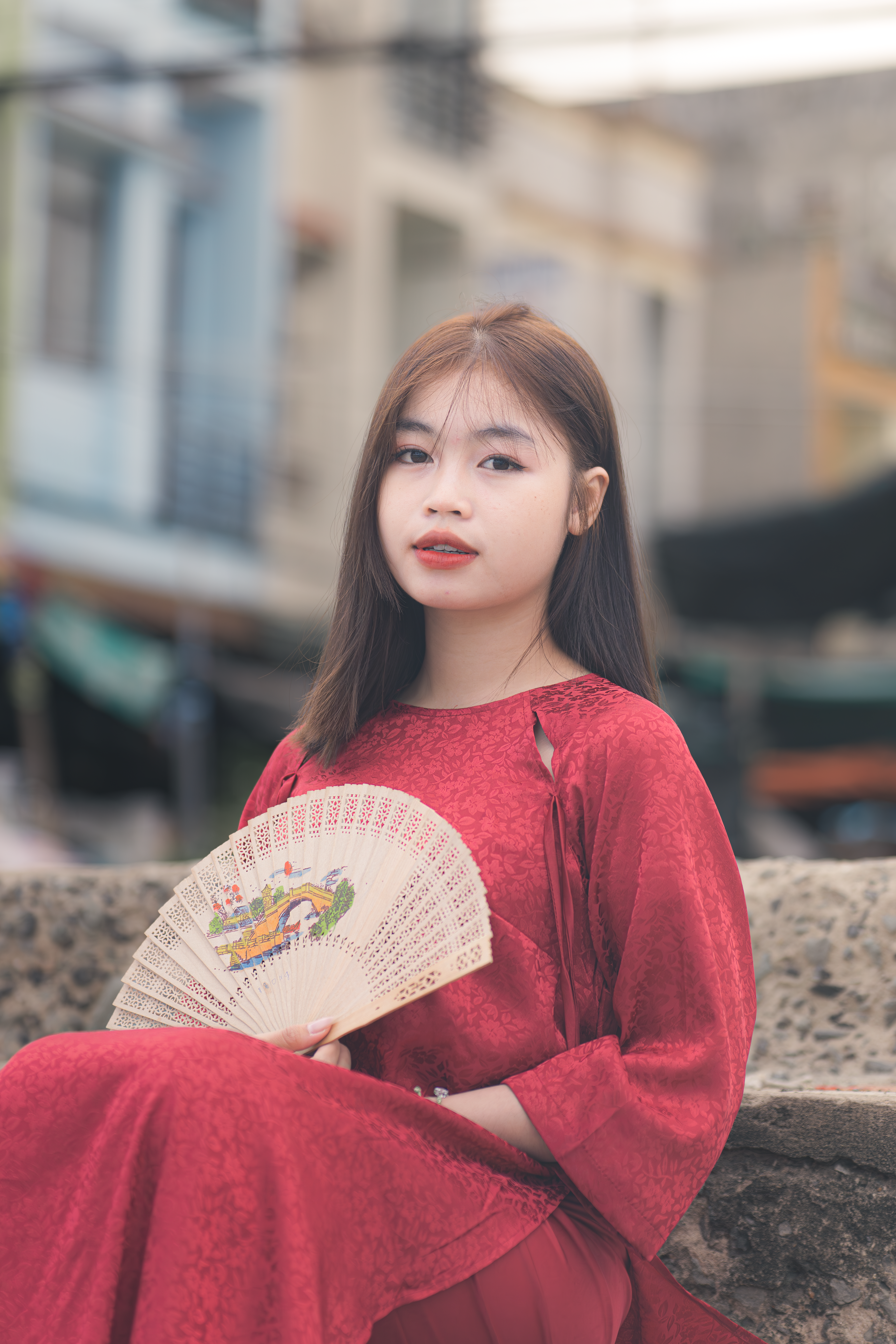 Young Woman in Traditional Red Dress Holding a Fan · Free Stock Photo