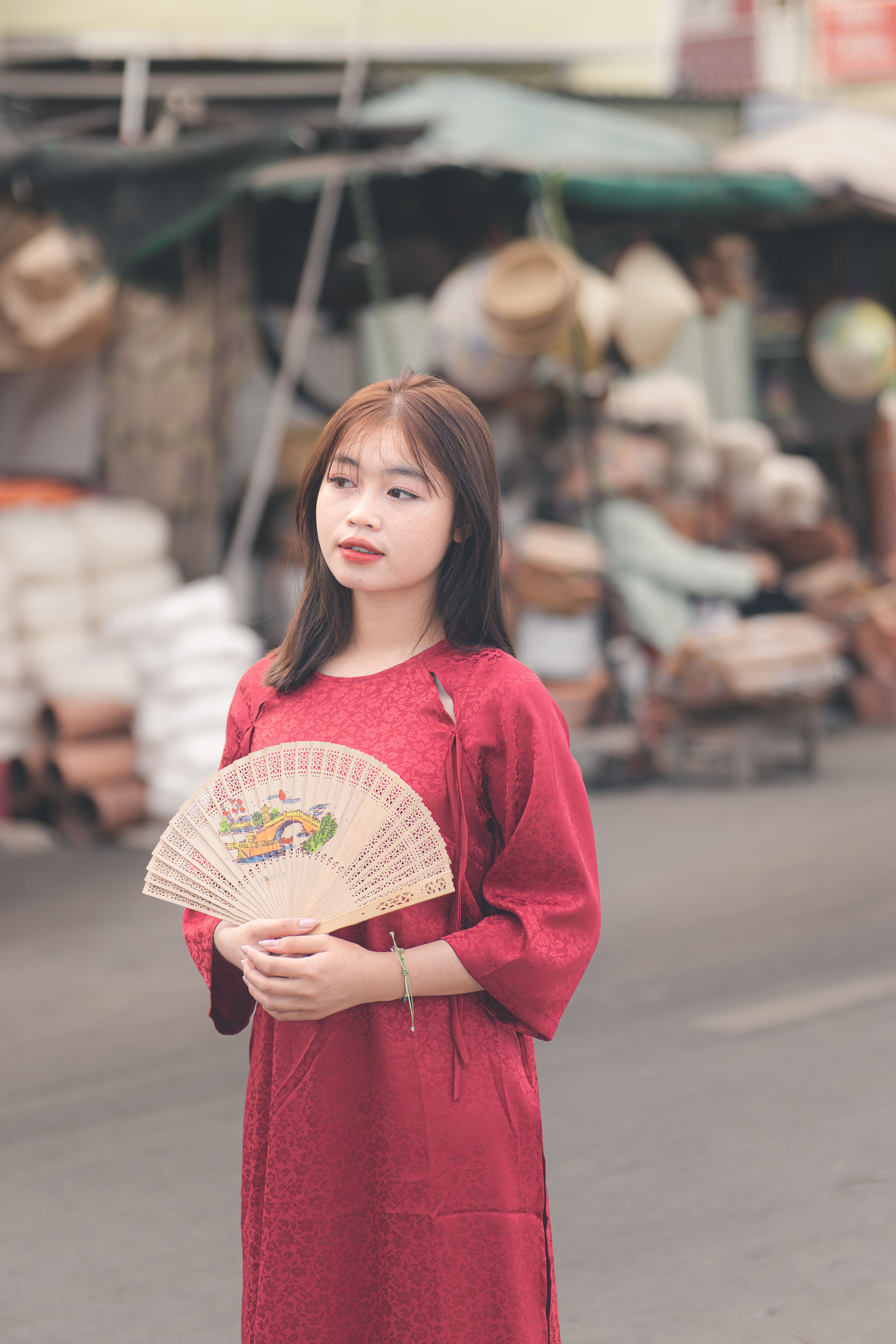 Young Woman Holding Fan in Market Street