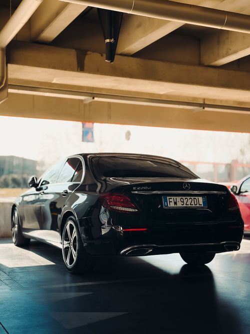 Free Sleek black sedan parked indoors, highlighting luxury automotive design. Stock Photo