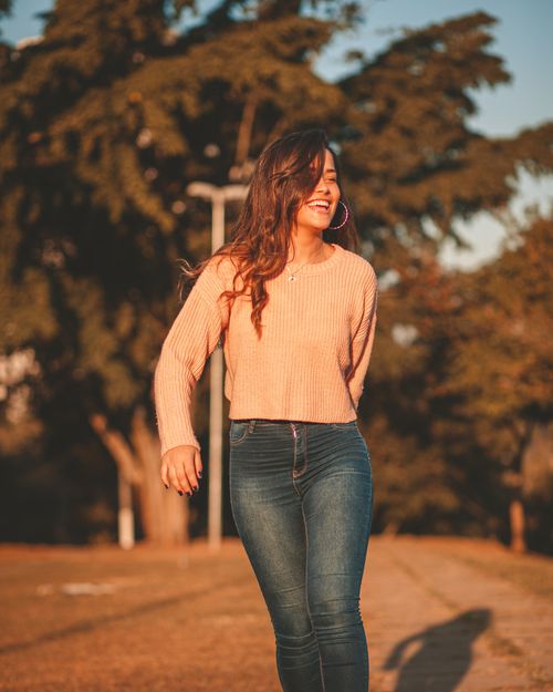 Free Cheerful woman with long hair enjoying a sunny day outside. Stock Photo
