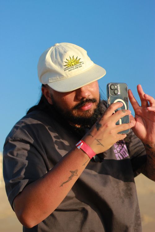 Free A person takes a photo on the beach of Nazaré, Portugal on a sunny day. Stock Photo