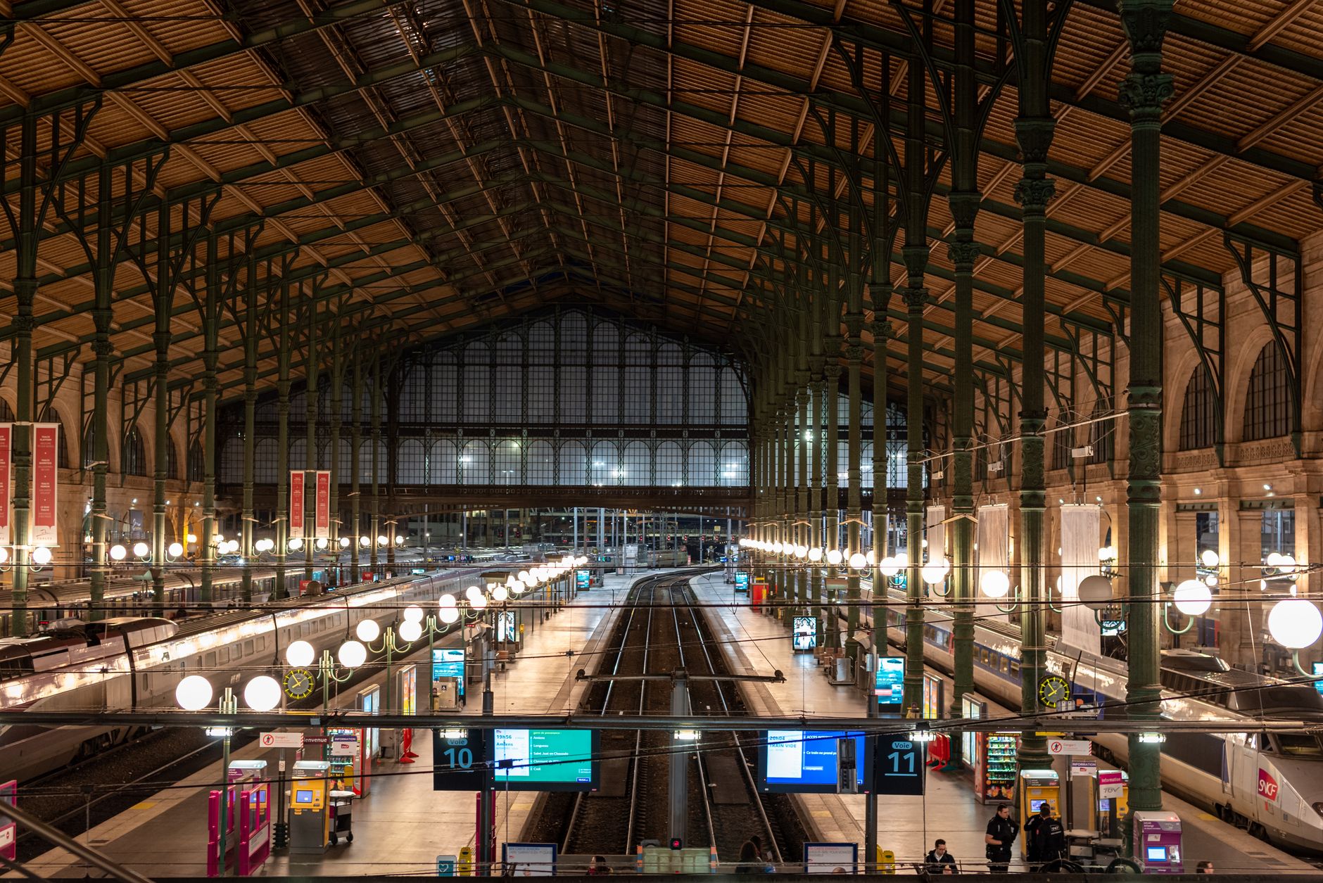 Interior view of Gare du Nord train station in Paris, showcasing its architecture and tracks.