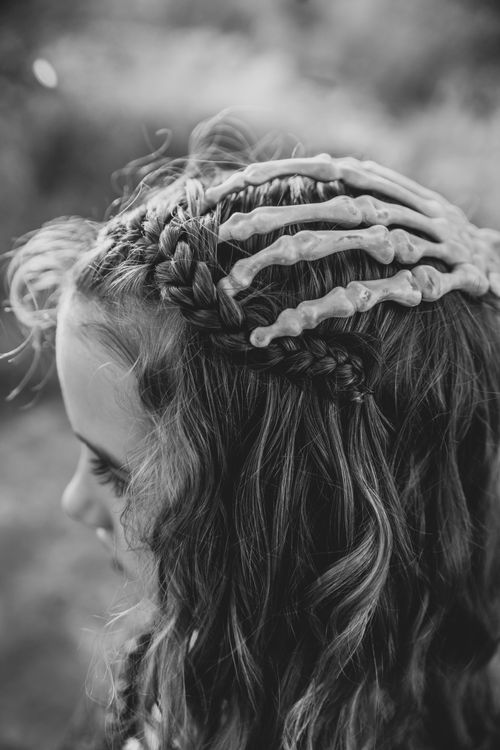 Free Black and white image of braided hair with a spooky skeleton clip for Halloween. Stock Photo