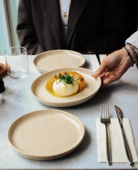 A sophisticated dining setup with burrata cheese dish being served at an Istanbul restaurant.
