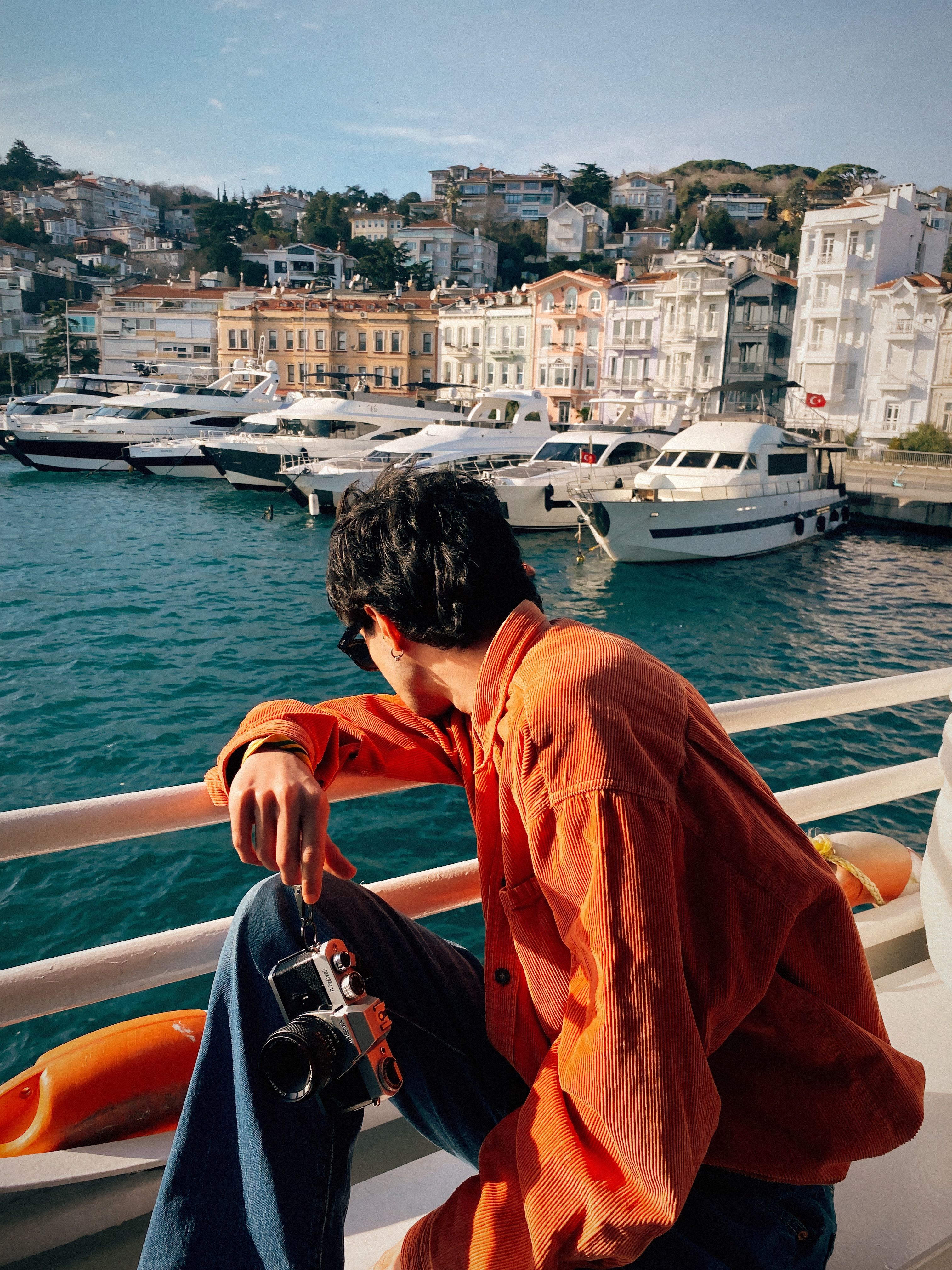 Person Observing Scenic Harbor View from Boat · Free Stock Photo