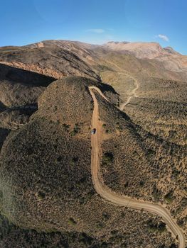 Aerial view of a winding dirt road in the Western Cape mountains, South Africa.