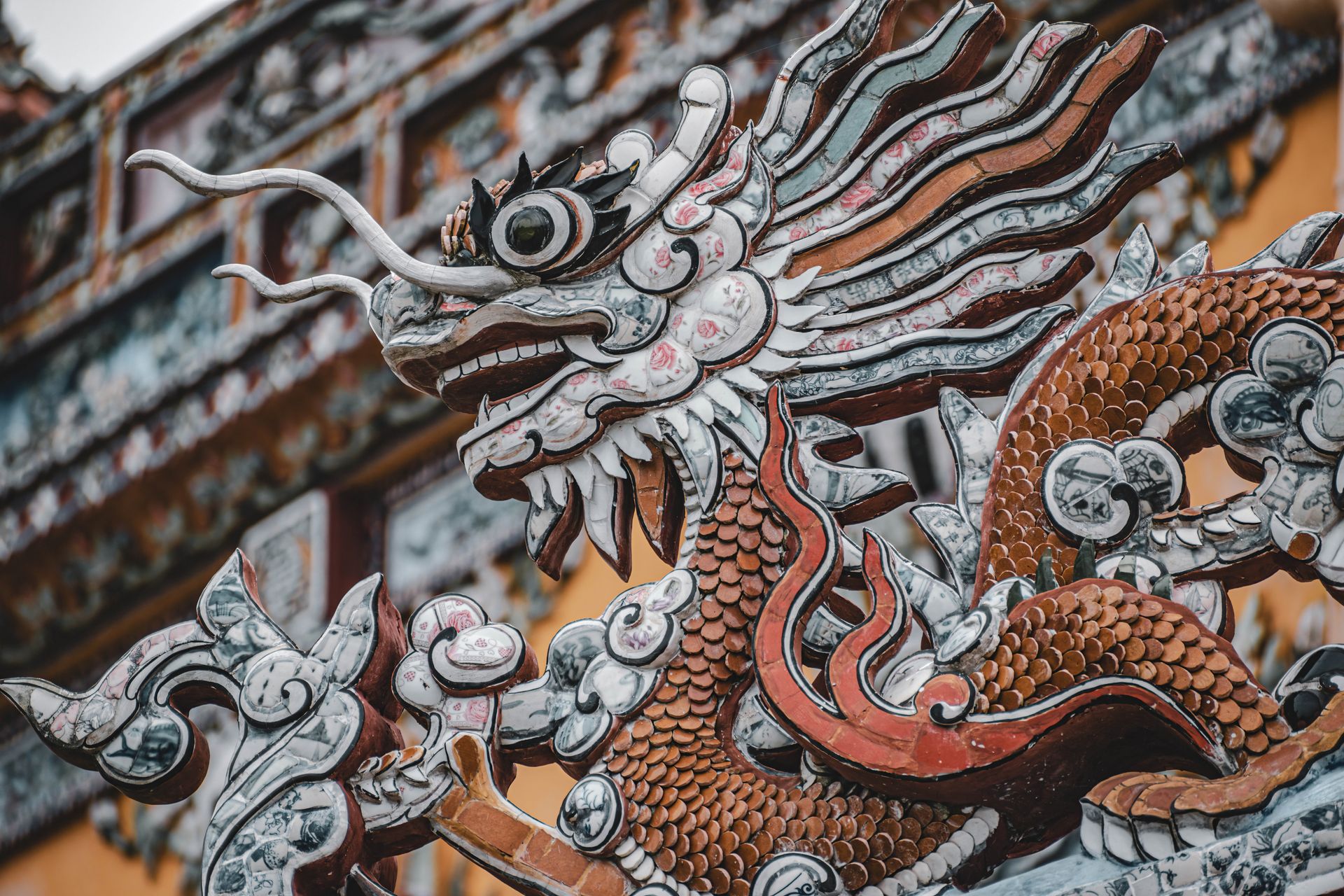 Close-up of a detailed dragon sculpture in a traditional Chinese temple setting.