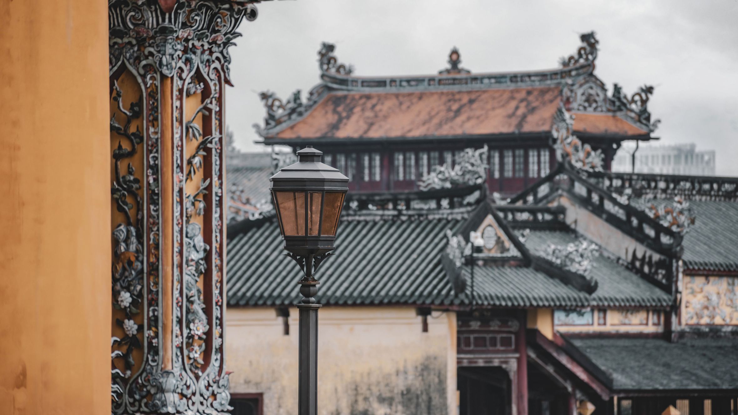 Detailed view of traditional architecture in the Huế Imperial City, Vietnam, showcasing ornate details and craftsmanship.