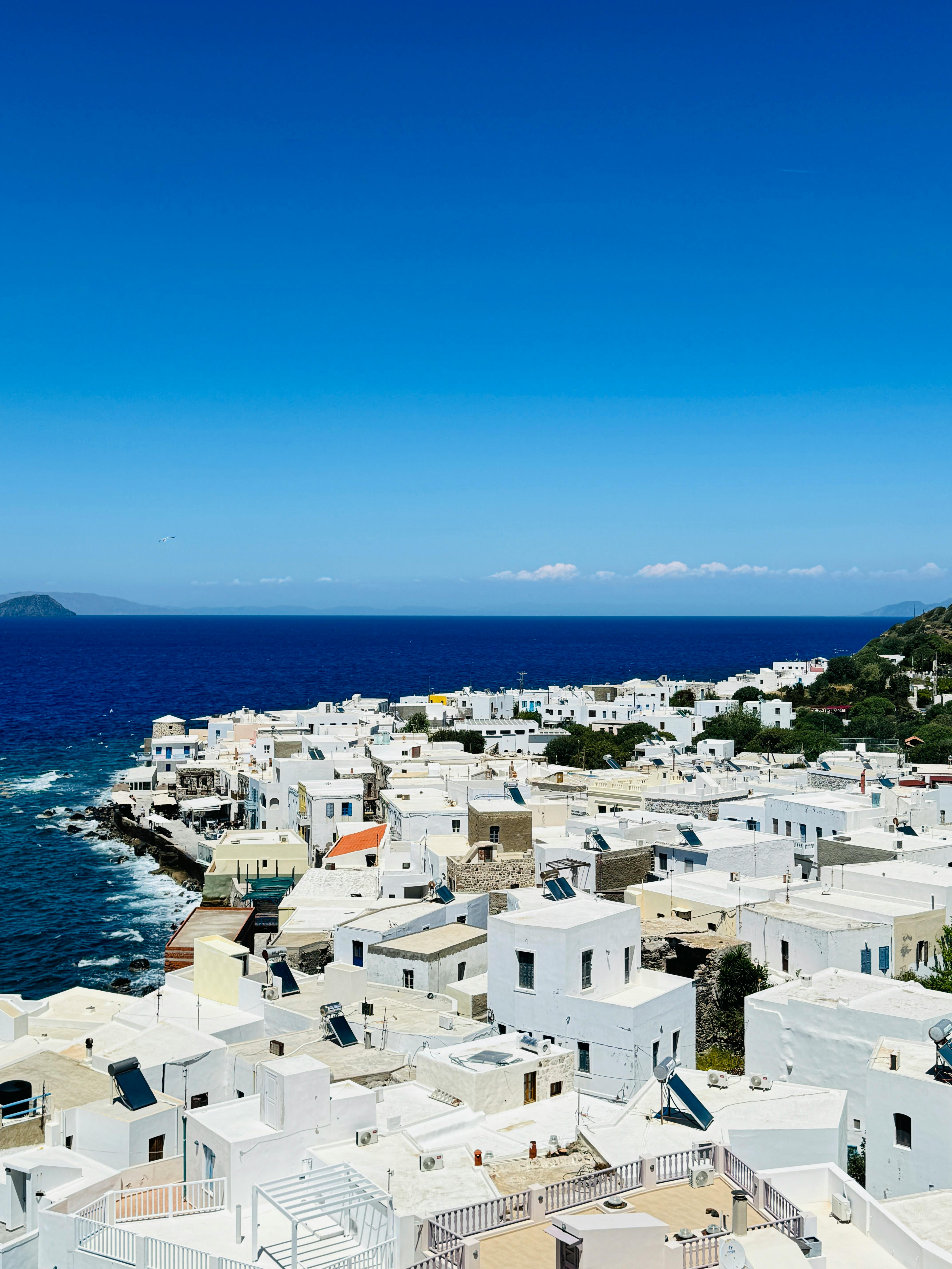 Breathtaking view of white Greek houses and the deep blue Aegean Sea on Symi Island.