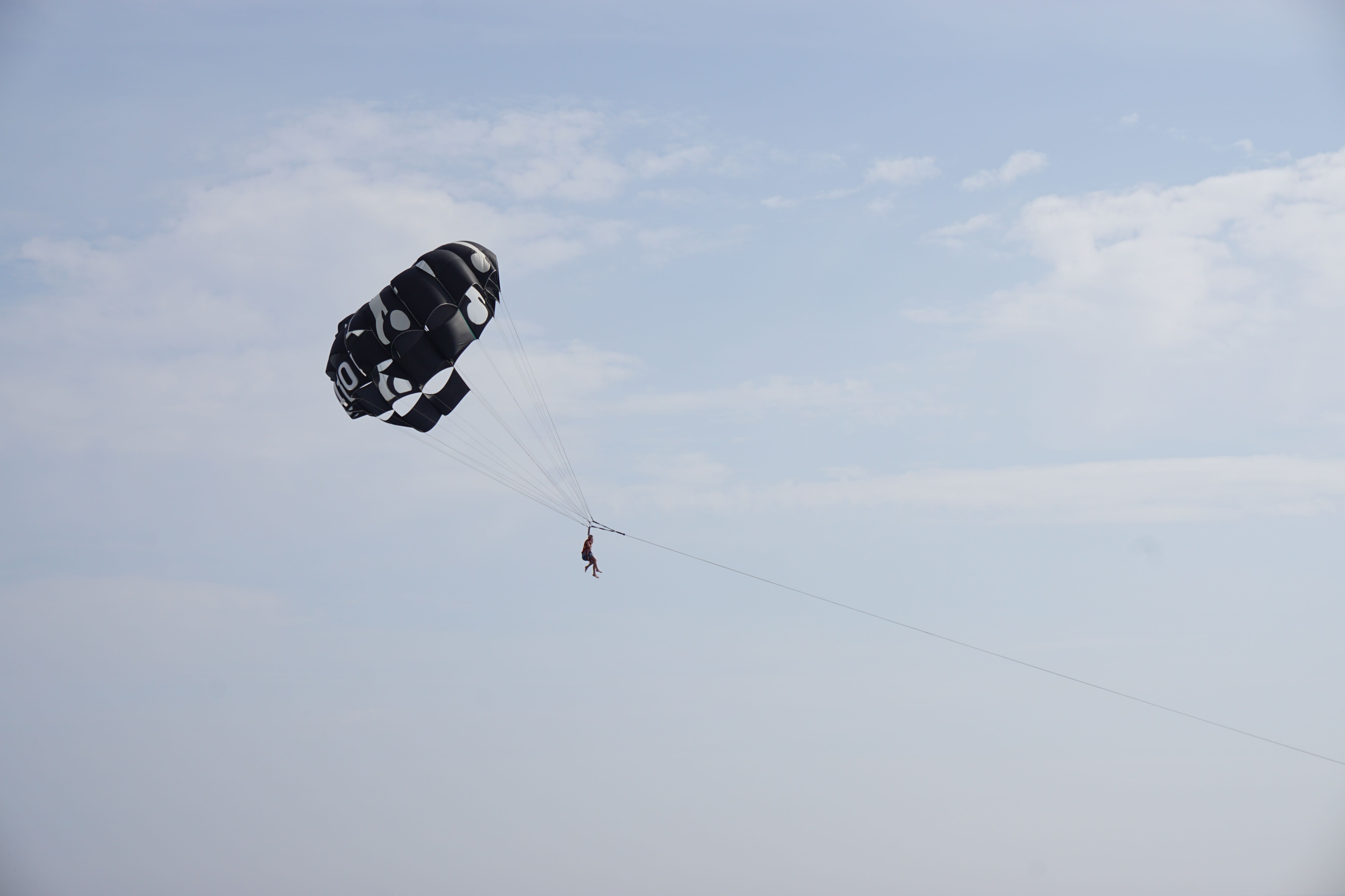 Captivating shot of parasailing in clear sky, perfect for adventure themes.
