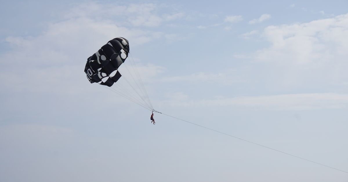 Captivating shot of parasailing in clear sky, perfect for adventure themes.