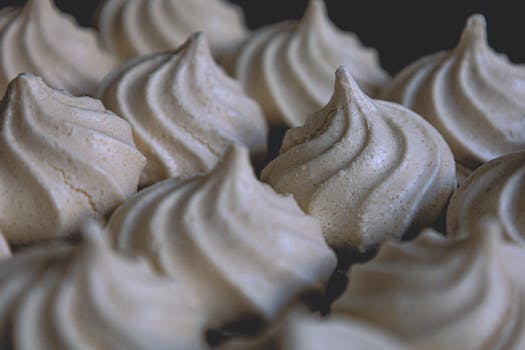 Elegant meringue desserts photographed close-up, showcasing their artisan texture and form in Lisbon.