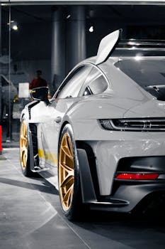 High-angle view of a luxury sports car showcasing its design and golden rims.