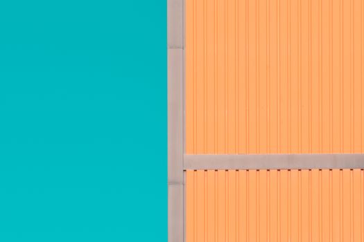 A vibrant, minimalist architectural facade featuring color contrast between orange and teal in Oslo, Norway.