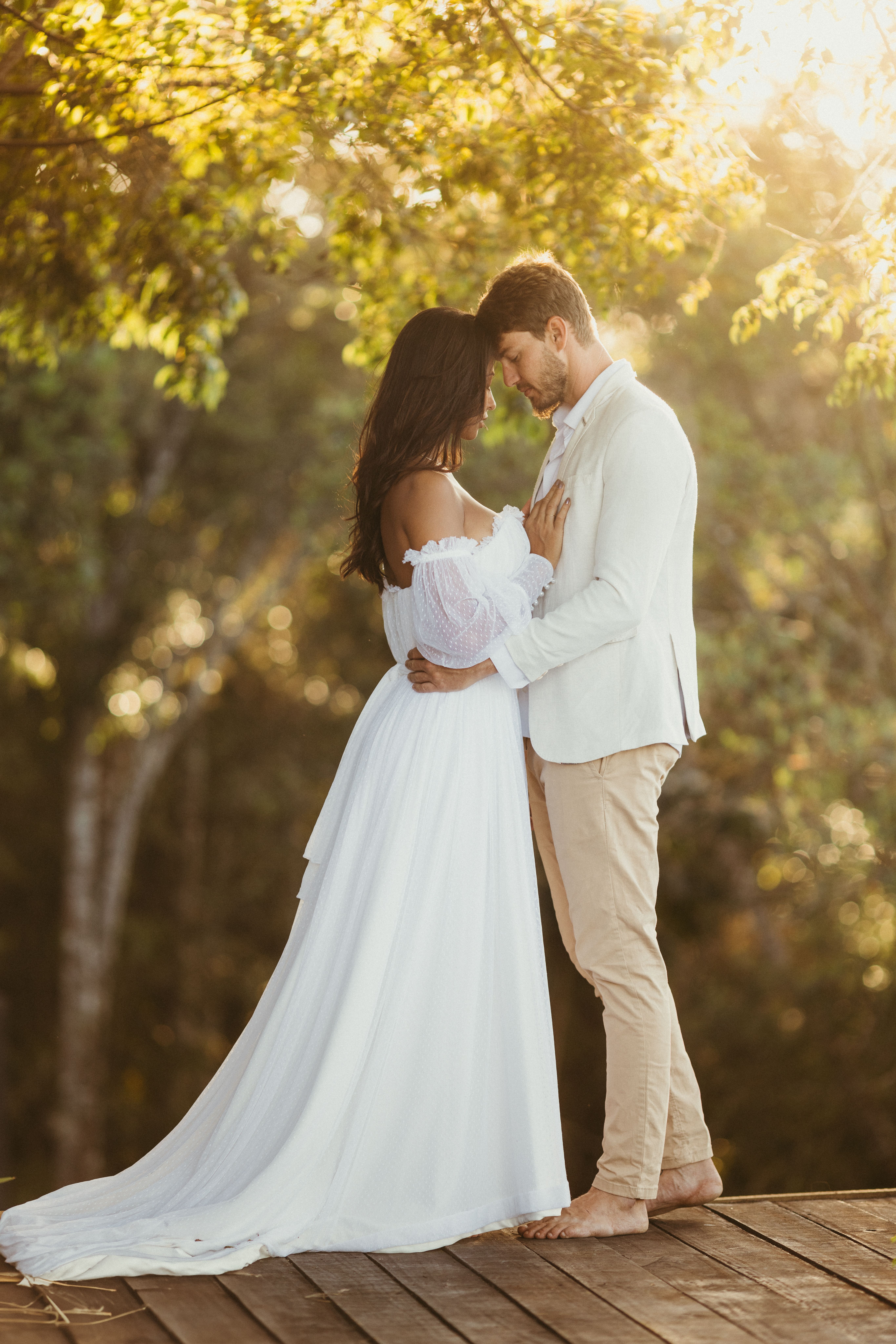 Romantic Couple Embracing Outdoors at Sunset · Free Stock Photo