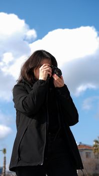 Young woman in İstabul capturing the skyline with her camera.